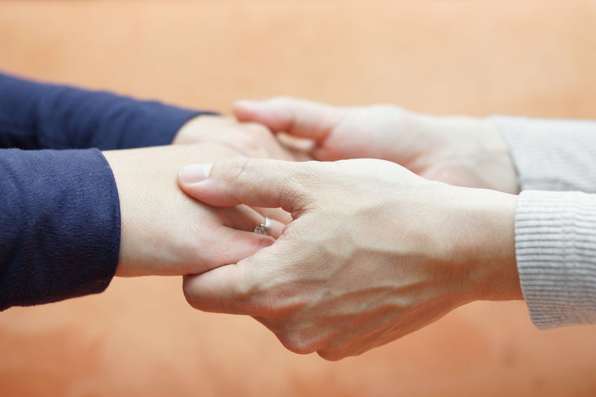 Family hands joined in support